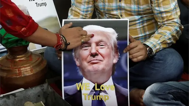 A priest applies a "tika" on the portrait of Republican U.S. presidential candidate Donald Trump, during a special prayer organised by Hindu Sena, a Hindu right-wing group, to ensure his victory in the upcoming elections