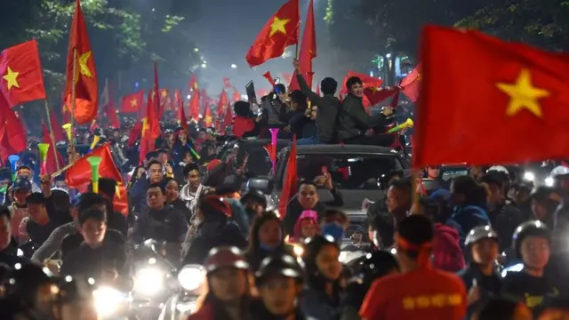 Người Việt Nam ăn mừng trên đường phố ở Hà Nội sau chiến thắng của Việt Nam trước Indonesia trong trận chung kết bóng đá nam tại SEA Games vào cuối ngày 10 tháng 12 năm 2019