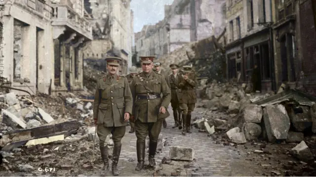 General Sir Sam Hughes and party looking at ruins in Arras, France August, 1916