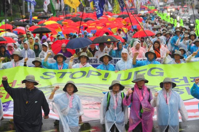 South Korean protesters hold a banner reading "Stop! UFG (Ulchi-Freedom Guardian joint military exercise)" as they march towards the US embassy during an anti-US rally demanding peace in the Korean Peninsula in Seoul on 15 August 2017.