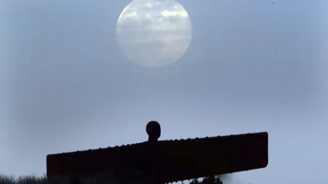 A pink supermoon is seen over the Angel of the North in Gateshead