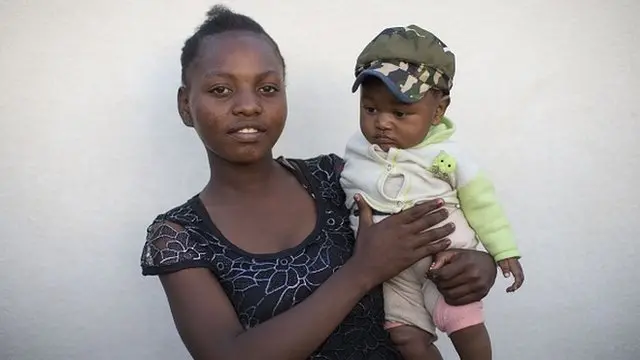 Njaka Ikandrina holding her child in her arms