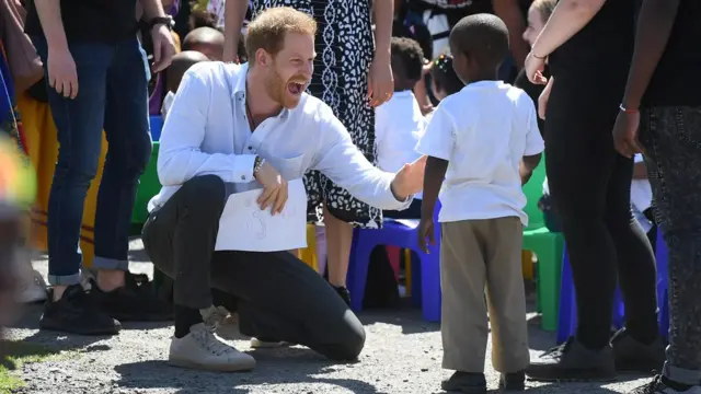 Prince Harry and a young boy in South Africa