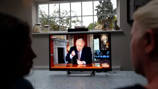 People watching the address on TV