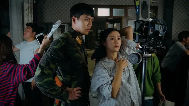 Lead actor and actress monitoring the recording