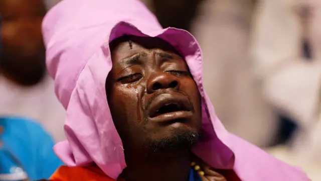A man cries during mass in Kibera, Nairobi, Kenya - Sunday 22 March 2020