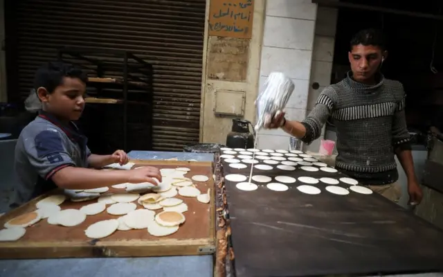 An Egyptian baker prepares Qatayef at a market in Cairo.