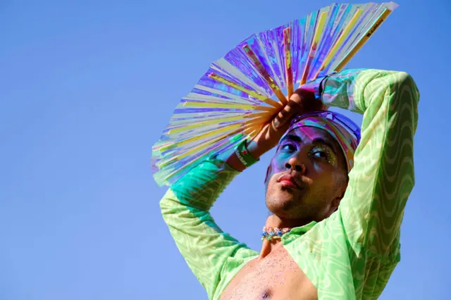 A reveller poses for photos at the music and arts festival Coachella, in Indio, California, on 24 April 2022