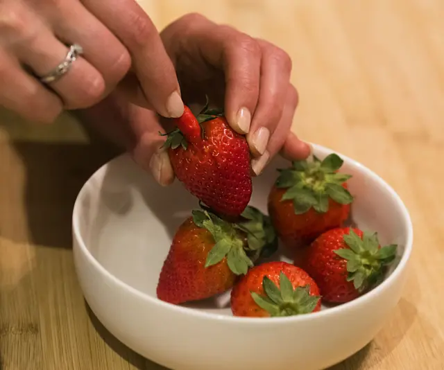Playing a prank on April fools day hiding a a hot chilli inside a strawberry
