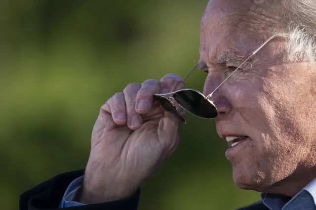 Joe Biden takes off his sunglasses