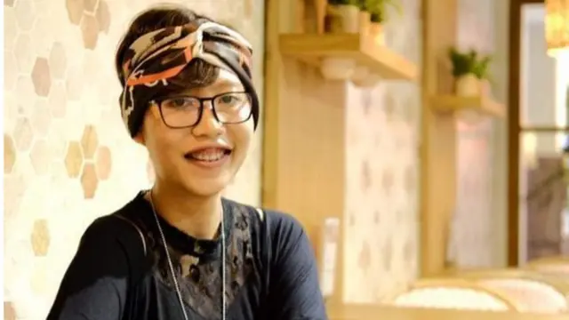 Indonesian woman with glasses wearing scarf around head