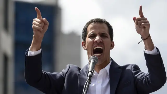 Venezuela"s National Assembly head Juan Guaido speaks to the crowd during a mass opposition rally