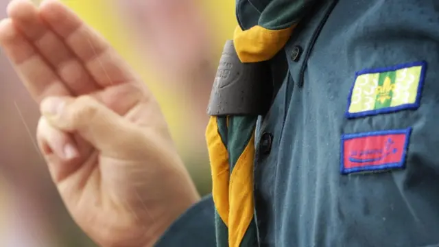 طفل يشير بقسم الكشافة