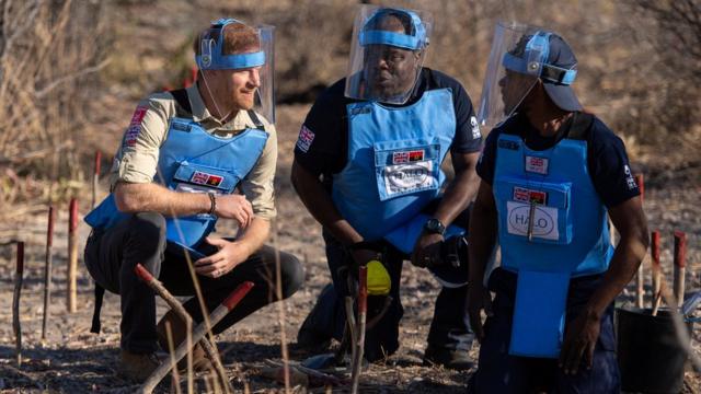 Prince Harry crouches alongside Halo staff