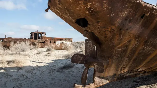 生锈的船只陷于乌兹别克斯坦的沙漠中，这里曾是木伊那克昔日的码头 。