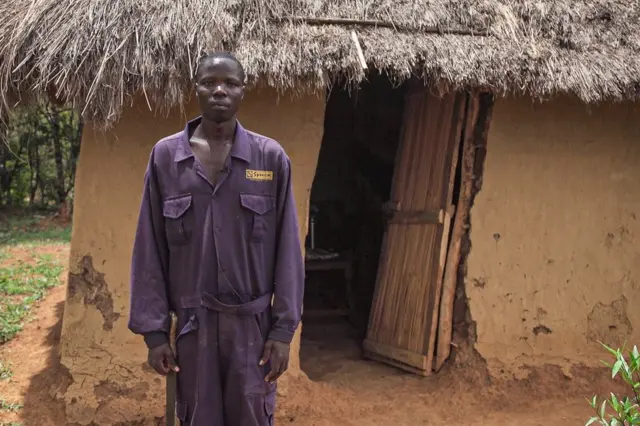 Simeon Randinga in front of his home now