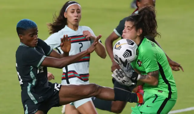 Nigeria forward Rasheedat Ajibade tries to kick a loose ball before Portugal goalkeeper Inês Pereira makes the save
