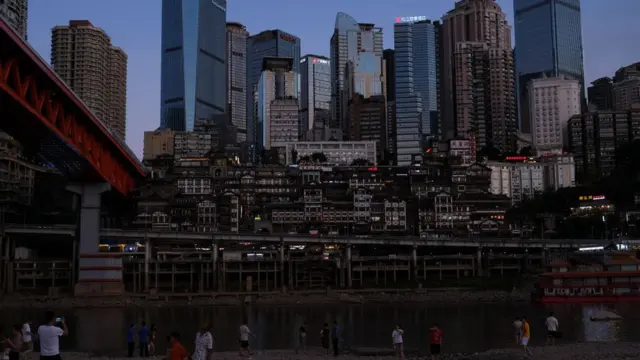 The Hongyadong (Hongya Cave), a comprehensive wooden stilt houses located at the junction of the Yangtze River and the Jialing River, is seen at night on August 21, 2022 in Chongqing, China. Lighting for outdoor wall decoration signs was suspended from Sunday in an effort to save electricity. Public lighting in the scenic area has been reduced by three-quarters and the Hongya Dripping was also temporarily closed