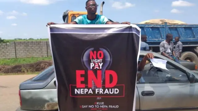 Protester carry banner for Abuja protest