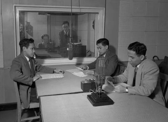 Rekaman acara 'Inggris pekan ini' untuk BBC Siaran Timur Jauh, bersama penyiar Ir R.M. Soediro, L.E.S. Wairatai dan R.T. Kamaraga, dari BBC Indonesia, beserta G.A.M. Hils yang berada di ruang kontrol (kanan, berdiri), 12 Februari 1951.