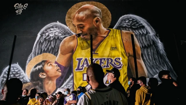 Lakers fans celebrate near a mural of Kobe Bryant and his daughter Gianna