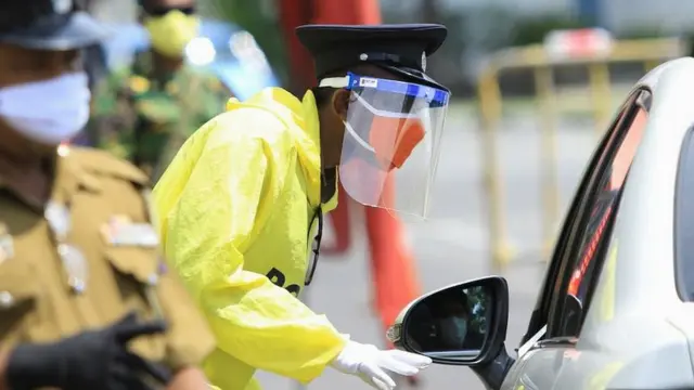 Police and army at a checkpoint during a curfew in Colombo