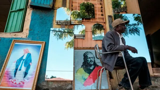 A man seats in front of a shop selling mirrors and paintings in Gondar, Ethiopia, on November 23, 2020.