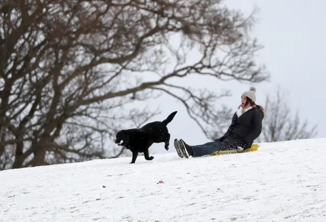 A person sledging in a snow covered Callender Park in Falkirk. Picture date: Monday February 8, 2021
