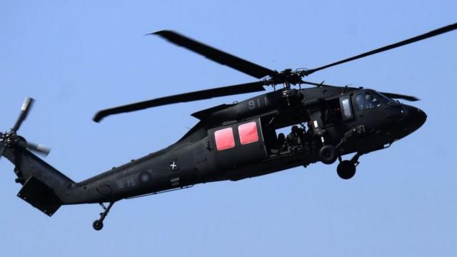 A mannnequin is thrown from a US-made Black Hawk helicopter during an annual military drill in Taichung, central Taiwan, on January 17, 2017.