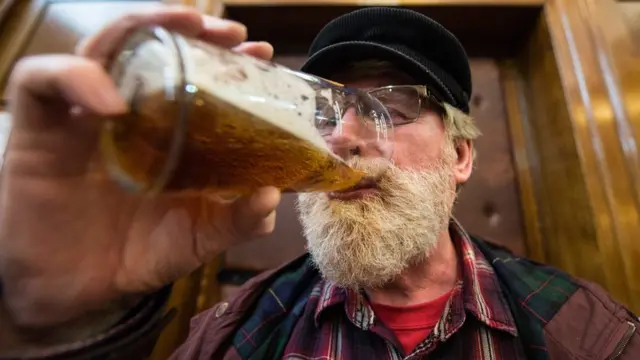 London, man drinks beer