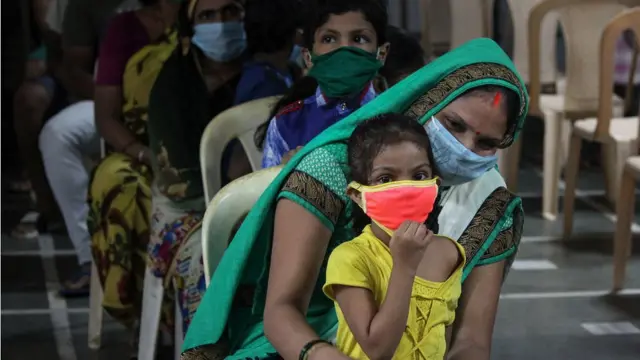 মুম্বাইয়ে পরীক্ষার অপেক্ষায় শিশুকে নিয়ে এক নারী এবং আরও রোগী