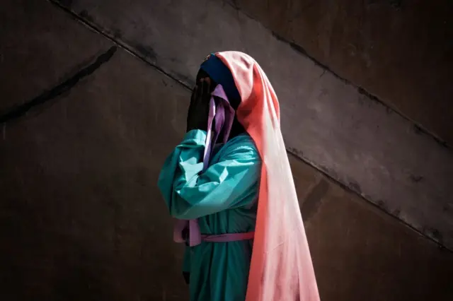 A member of the Christian Church Jowani Masowe Vadzidzi Vajesu awaits the beginning of the newly sworn-in President Inauguration ceremony at the National Sport Stadium in Harare, on November 24, 2017. Zimbabwe's newly sworn-in President Emmerson Mnangagwa vowed during his inauguration speech on November 24 to protect foreign investments in the country as he sought to lay out his economic credentials. 'In this global world no nation is, can, or need be an island. All foreign investments will be safe in Zimbabwe,' he told a crowd of tens of thousands at his inauguration ceremony.