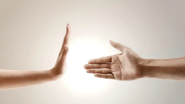 Mano rechazando otra mano