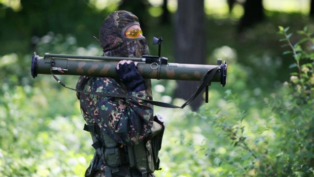 A pro-Russian militant holds a rocket launcher during combat with Ukrainian troops in Donetsk, May 2014