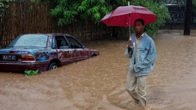 A man wades through rising floodwaters in Pemba, Mozambique after Cyclone Kenneth struck the African nation