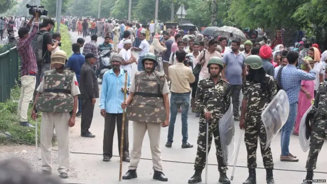 Security forces are seen after Dera followers fire up the vehicles in Panchkula sector 4 after the Dera chief verdict at CBI court on August 25, 2017 in Panchkula, India