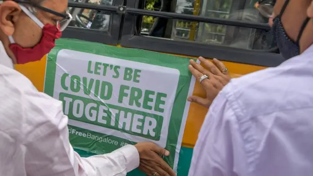 Officials put up a Covid public health sign in Bangalore, India