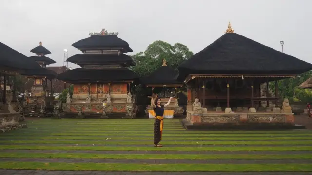 Seorang turis berpose di Pura Puseh Batuan Gianyar (30/01). Pura Batuan terlihat lengang karena tidak ada turis Cina yang pada hari biasa mencapai sekitar 1.000 per hari.