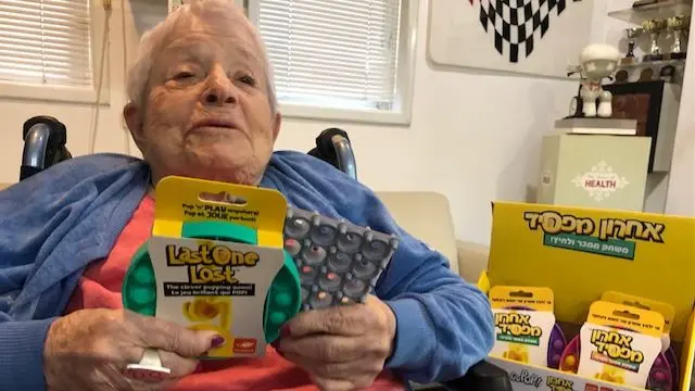 Ora Coster holding a Last One Lost pop-it game