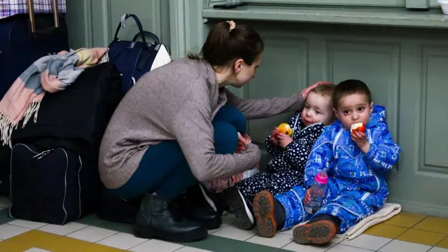 Madre acaricia a sus dos hijos pequeños