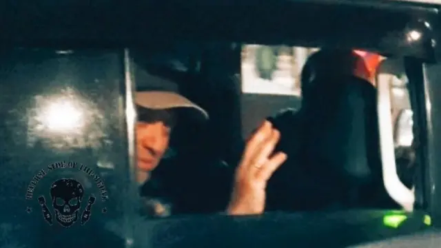 Yevgeny Prigozhin waves from inside a car