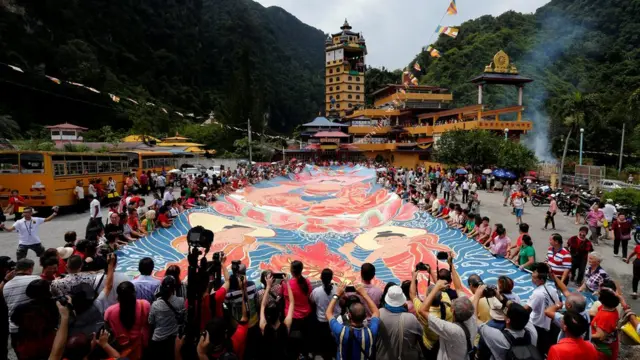 Buddhist devotees display a giant thangka, a sacred painting on cloth, on Vesak Day at the Enlightened Heart Tibetan Buddhist temple in Ipoh, Malaysia May 29, 2018