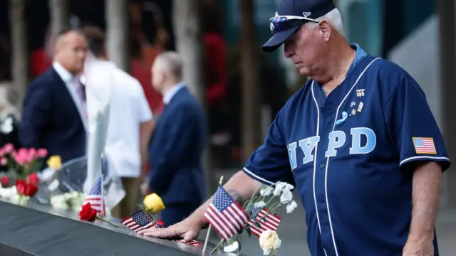 Man with his hand on the memorial