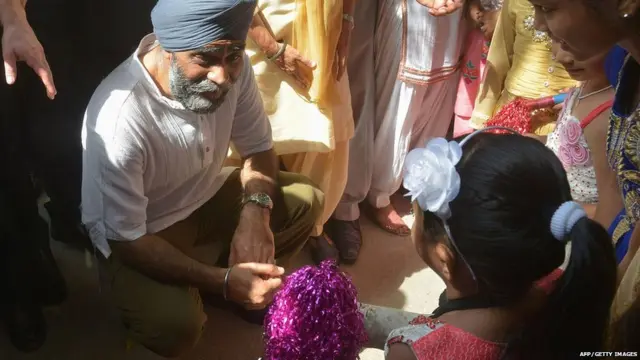 Canada's Defence Minister Harjit Singh Sajjan (C) talk with children during his visit to the All India Pingalwara Charitable Society (AIPCS) at Manawala village on the outskirts of Amritsar on April 20, 2017.