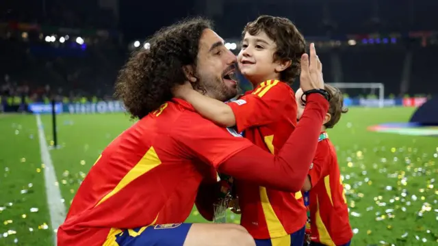 Marc Cucurella, defensa del equipo de España, celebra la victoria con sus hijos y abraza a Mateo, diagnosticado con un trastorno del espectro autista.