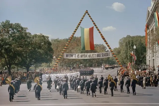 Kerumunan di bawah spanduk menyambut Haile Selassie