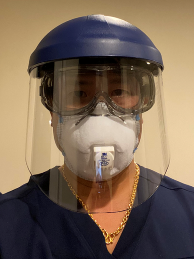 Dr Edward Chew wearing a visor and protective mask
