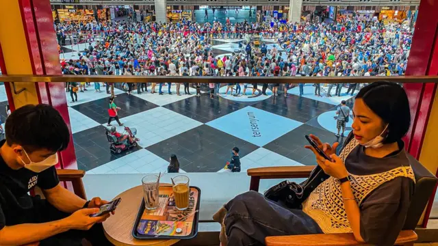 People queue to get their Covid-19 booster jab inside the Taipei Metro station in Taipei, Taiwan, 23 April 2022. Local authorities said on 22 April,