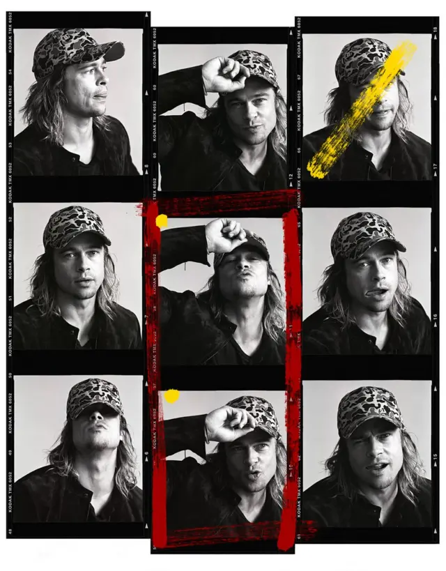 Brad Pitt poses in a cap