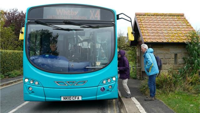 People boarding a bus in Whitby